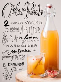 a bottle of cider punch next to a glass and pitcher