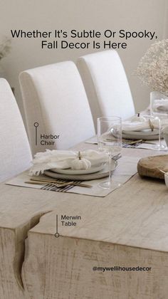 the table is set with white chairs and place settings