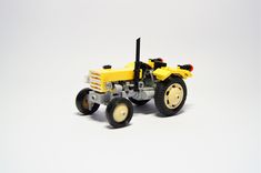 a toy tractor is shown on a white background with no people in the photo to provide a caption for