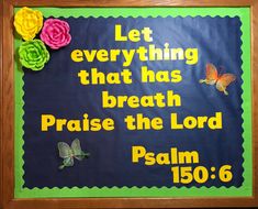 a bulletin board with flowers on it and a bible verse written in the bottom corner