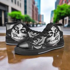 a pair of black and white shoes with a skull on the side, in front of a city street