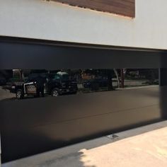 a black truck parked in front of a garage door