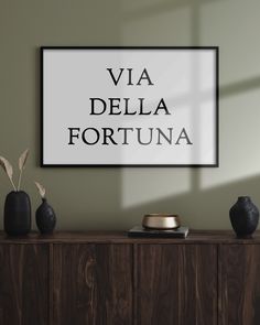 there is a sign that says via della fortuna on the wall above it