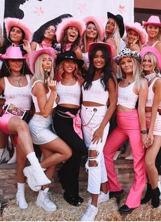 a group of women in pink hats posing for a photo