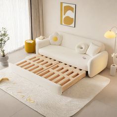 a white couch sitting on top of a rug in a living room