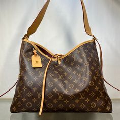 Brand: Louis Vuitton Color: Brown Material: Coated Canvas Type: Shoulder Bag Includes: Receipt & Pouch *At The Time Of Purchase In 2022 This Bag Had Retailed For $2500; However, The Price Has Gone Up To $2670 As Of 2024 * Approximate Measurements: L X H X D: 15.25" X 12.5" X 6.5" Strap Drop: 11" Description: B- Good Overall Condition. Moderate Imperfections (Scratches, Stains, Etc.) Wearable Without Repair, Although It Could Be Improved Upon With Repair If Desired. Indulge In Luxury With The Lou Loop Hobo Louis Vuitton, Lv Loop Hobo Bag, Louis Vuitton Hobo Bag, Louis Vuitton Carryall Mm, Louis Vuitton Brown Handbags, Louis Vuitton 2000s Bag, Elegant Bags, Monogram Prints, White Mark