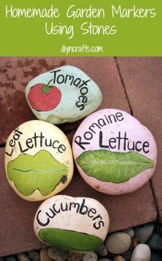 four rocks with words painted on them that read homemade garden markers using stones