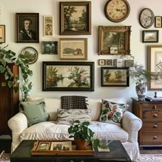 a living room filled with lots of framed pictures