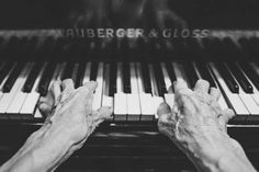 two hands playing an organ keyboard with the words auberger & gloss written on it