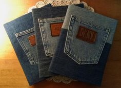 three denim napkins with leather labels on them sitting on a doily next to a lace doily