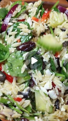 a bowl filled with rice and vegetables on top of a table