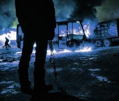 a man standing in front of a burning truck