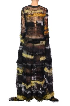 https://shoprodarte.com/pages/made-to-order This hand knit gown features a black knit bateau neckline atop a fitted bodice that flares from the hip into a softly undulating floor skimming skirt.  The open stitchwork knitted in a mohair/alpaca/silk yarn blend with embedded sequins creates an intriguing abstract pattern of black, silver, gold and yellow.  Dramatic floor length asymmetric bell sleeves with metallic silver knit edging complete the look. This style fits true to size, we suggest taking your normal size Model wears size XS/S Composition: 37% Superkid Mohair, 15% Alpaca, 15% Silk, 10% Cotton, 6% Nylon, 6% Wool, 5% Metallic Polyester, 3% Viscose,3% Rayon Hand knit Do not hang Hand spot lean only with wool cleaner and towel dry Made in the USA Knit Fashion Runway, Noro Knitting, Goth Chic, Knit Gown, Handmade Yarn, Knit Edge, Gown Black, Fashion Design Portfolio, Bateau Neckline