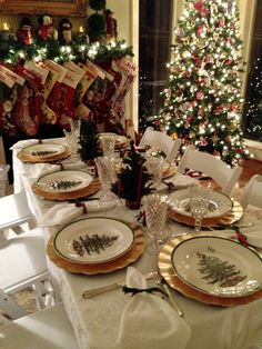 a dining room table set for christmas dinner