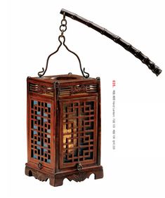 an old wooden lantern hanging from a metal hook on a white background with chinese writing below it