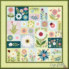 a patchwork quilt with flowers and leaves on the front, along with green border