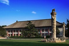 a large building sitting on top of a lush green field