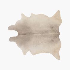 a cowhide rug is shown on a white background, with the reflection of an animal's head