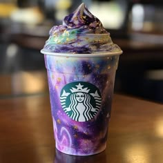 a starbucks drink with purple and green sprinkles