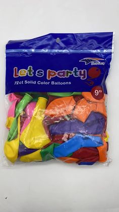 a bag filled with lots of different colored balloons