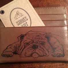 a brown leather wallet with a drawing of a dog on it