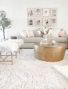 a living room filled with lots of furniture and pictures on the wall above it's coffee table