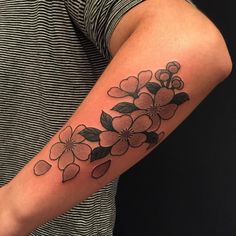 a person with a flower tattoo on their arm