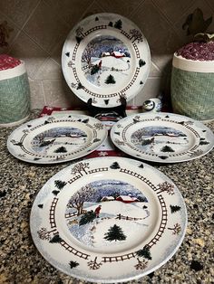 four christmas plates sitting on top of a counter