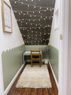 the hallway is decorated with string lights and white rugs on the wooden flooring