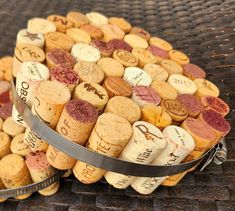 two buckets filled with wine corks sitting on top of a wicker table