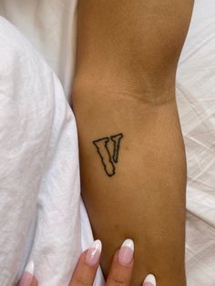 a woman's foot with a small tattoo on the left side of her leg