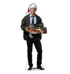 a man in a suit and tie holding presents under a christmas hat on a white background