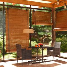 an outdoor dining area with wooden blinds and wicker furniture