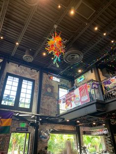 the inside of a building with many windows and lights on it's ceiling,