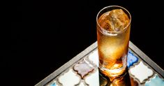 a glass filled with ice sitting on top of a table