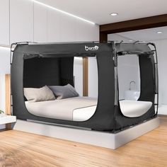 an inflatable bed with pillows on top of it is sitting on a hard wood floor