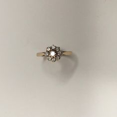 an engagement ring with two diamonds on top and one diamond in the middle, against a white background