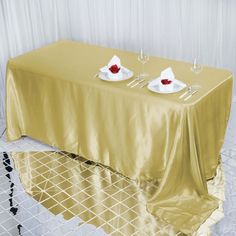 the table is set with two wine glasses on it