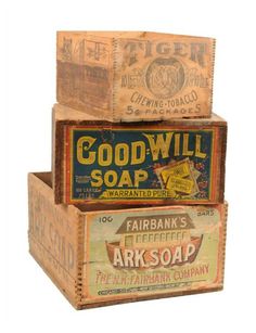 three wooden boxes stacked on top of each other with different types of soaps in them