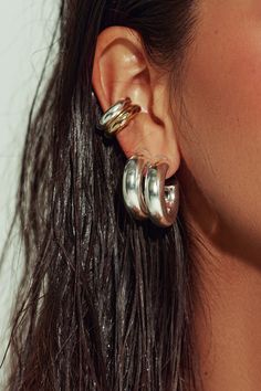 The pair to swear by. Sleek and sculptural - even in its lobe-hugging minutiae. Our sterling silver tube huggies are the most versatile earring you’ll ever own. Stack with hoops, cuffs or studs, wear just as accent pieces, or double up with our 10k gold version for a modern touch of tonal duality. Jewelry Collection Handcrafted in Brazil Sterling Silver over Brass Thickness: 7mm Diameter: 1" Weight: 0.20 oz Waterproof Hypoallergenic Silver Hoop Stack, Everyday Silver Huggie Ear Cuff, Silver Huggie Ear Cuff For Everyday Wear, Silver Chunky Earrings, Sterling Silver Huggie Ear Cuff, Silver Sterling Huggie Ear Cuff, Mixed Metal Earring Stack, Modern Silver Stainless Steel Huggie Earrings, Silver Nickel-free Huggie Ear Cuff