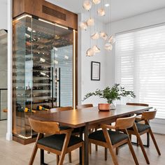 a dining room table with chairs and a wine rack