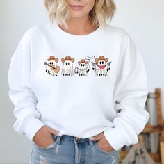 Stay cozy and stylish in our Cowboy Ghosts Sweatshirt. This western-inspired sweater features cute ghost designs that will add a playful touch to your wardrobe. Get ready to turn heads and keep warm in our unique and fun sweatshirt. Fall Character Print Relaxed Fit Sweatshirt, White Cartoon Print Sweater For Fall, White Sweatshirt With Character Print For Fall, White Fun Sweater For Fall, White Cartoon Print Sweatshirt For Fall, Fun White Sweater For Fall, Ghost Design, Fun Sweatshirts, Cute Ghost