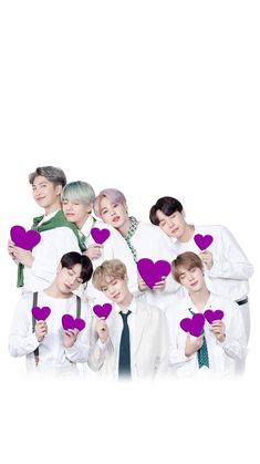 the group is holding up hearts in front of their faces