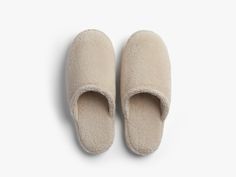 Step into something more comfortable. Designed to match our best-selling Classic Bathrobe, these cozy cushioned slippers feature plush terry fabric and ribbed rubber soles. Soft and breathable, they’re footwear made for lounging in luxury. Classic Slippers, Slippers, Fabric