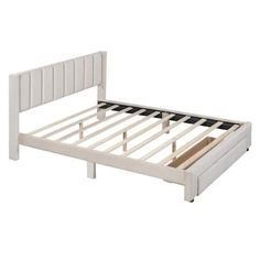 a white bed frame with wooden slats