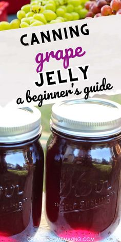 two jars filled with purple jelly sitting on top of a table next to some grapes