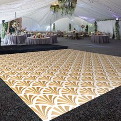 an orange and white dance floor in a tent