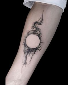 a woman's arm with a black and white tattoo design on the left forearm