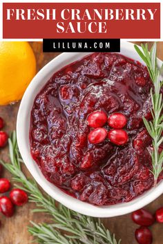 cranberry sauce in a white bowl with rosemary sprigs on the side