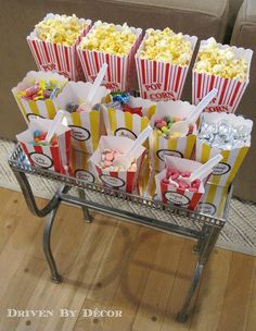 a metal cart filled with popcorn bags on top of a wooden floor